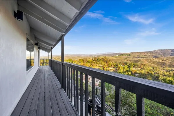 a living room with furniture pool table and chairs