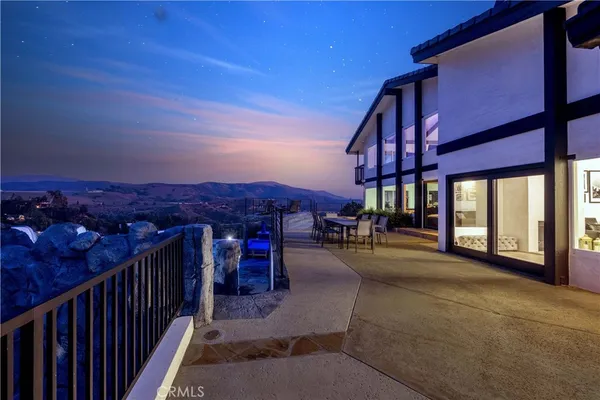 a large kitchen with kitchen island a large counter top space a sink and appliances