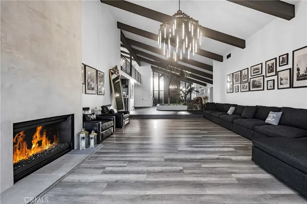 a living room with lots of furniture and wooden floors