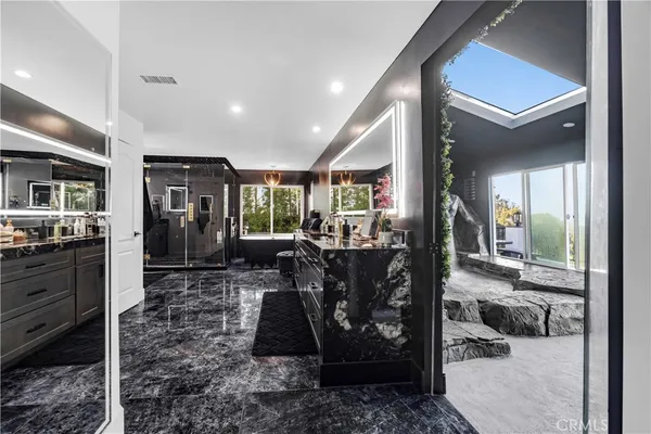 a living room with a bed furniture and a flat screen tv