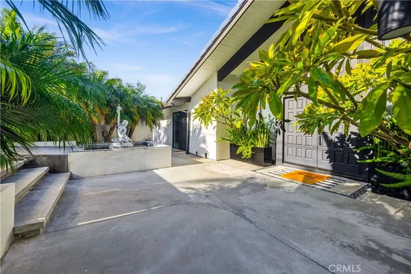 a backyard of a house with seating space and entertaining space