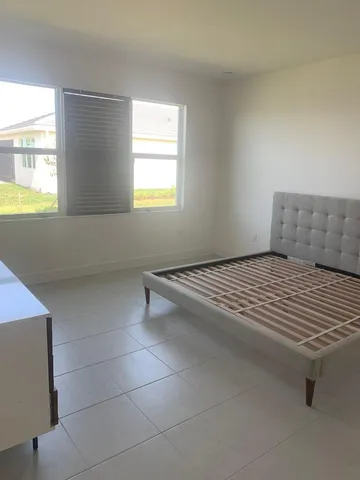 a bathroom with bathtub and window