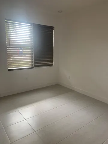 a bathroom with a granite countertop toilet sink and mirror