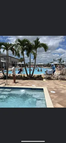 a front view of a house with a garden and parking space