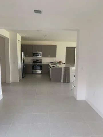 a kitchen with stainless steel appliances a stove top oven and cabinets