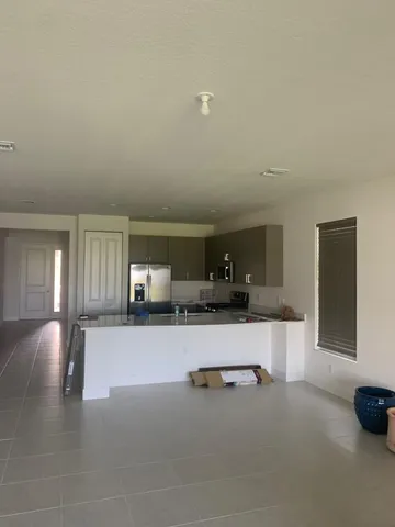 a kitchen with a sink cabinets and a large window