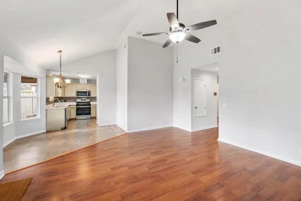 a view of a kitchen with a sink and a kitchen island