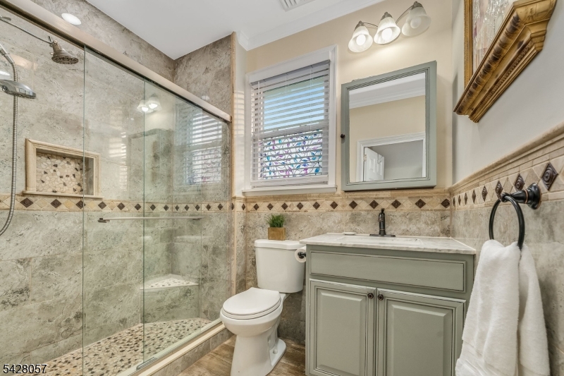 119 Edgewood Road Linden, NJ 07036 - Photo 16 of 31 a bathroom with a sink toilet a mirror and shower