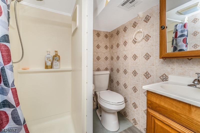 119 Edgewood Road Linden, NJ 07036 - Photo 21 of 31 a white toilet sitting next to a bathroom sink