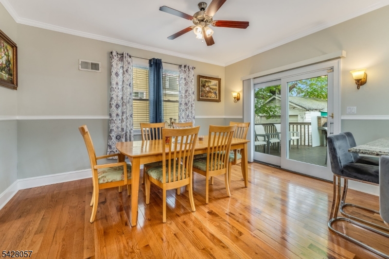 119 Edgewood Road Linden, NJ 07036 - Photo 7 of 31 a dining room with furniture a chandelier and wooden floor