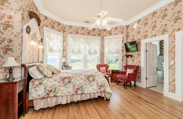 a bedroom with a bed dresser and a flat screen tv