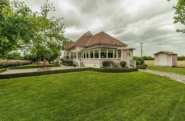 a view of a house with a yard patio and swimming pool