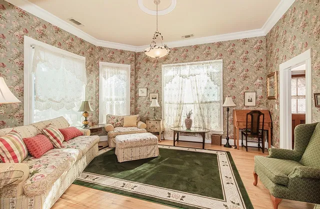 a living room with furniture large window and a chandelier