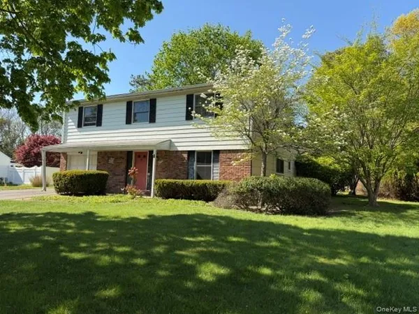 a view of a house with a yard and sitting area