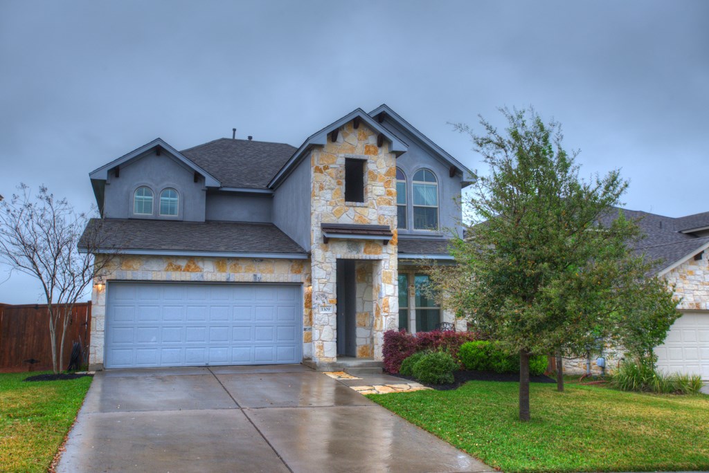 a front view of house with yard and green space
