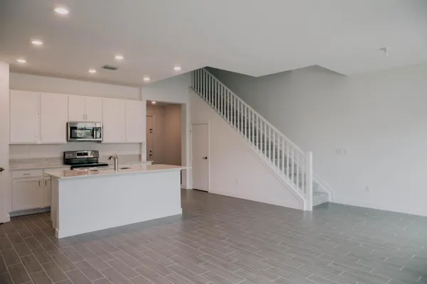 a kitchen with stainless steel appliances a refrigerator and a stove top oven