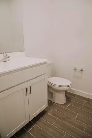a bathroom with a sink toilet and a mirror