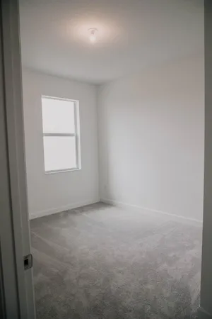 a bathroom with a granite countertop toilet and mirror