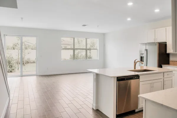 a kitchen with a sink a window and stainless steel appliances