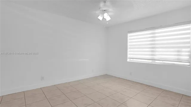 a view of a chandelier fan and entryway