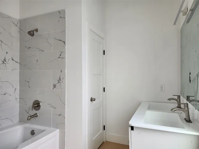 a bathroom with a tub and a sink