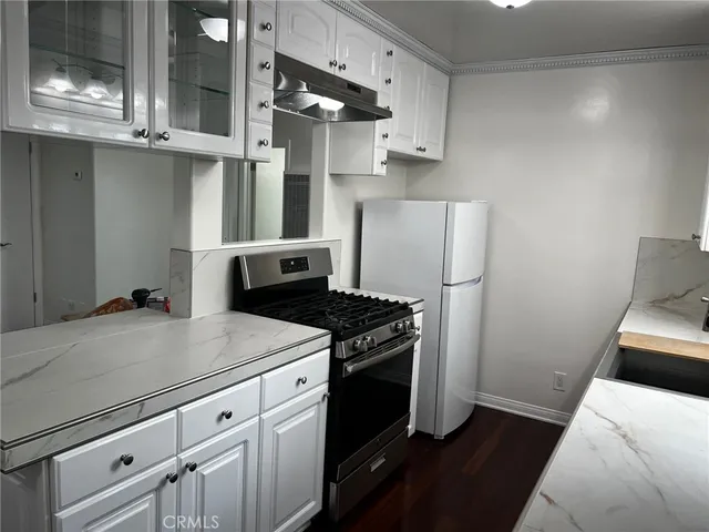 a kitchen with a stove and a refrigerator