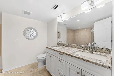 a bathroom with a bathtub shower sink and toilet