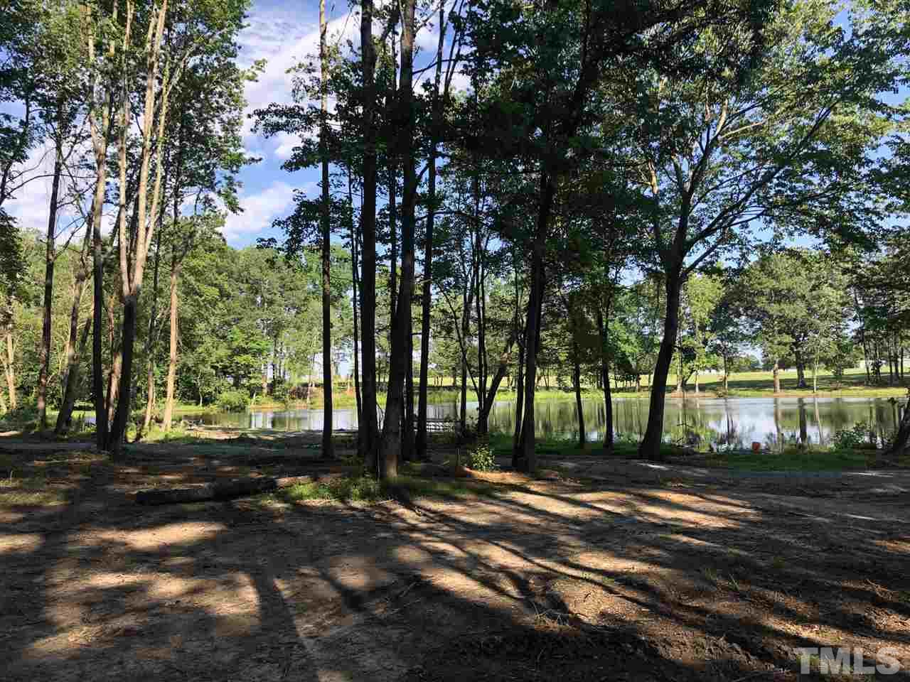 1911 Eddie Howard Road Willow Spring, NC 27592 - Photo 12 of 12 a backyard of a house with lots of green space