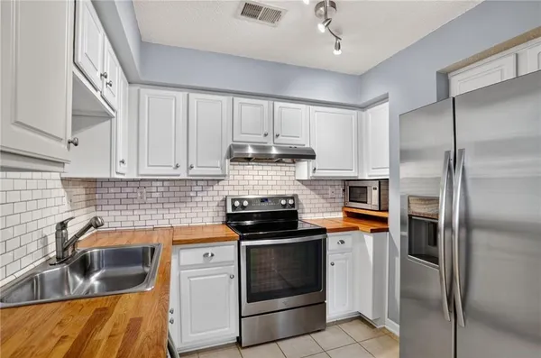 a kitchen with a sink stove and refrigerator
