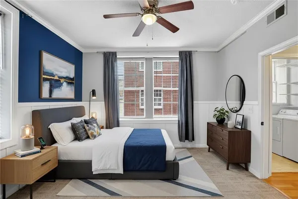 a bedroom with a balcony a bed and a chandelier