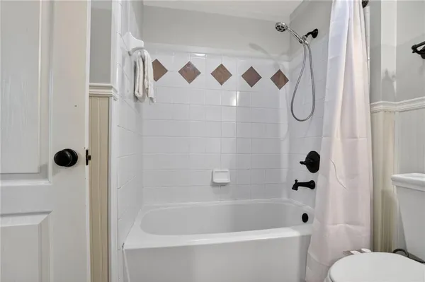 a bathroom with a shower and a toilet