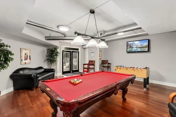 a room with furniture and pool table