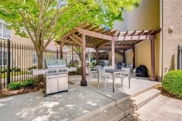 a view of a patio with a table and chairs and potted plants