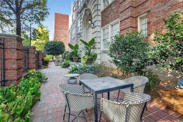 a view of a patio with table and chairs and potted plants