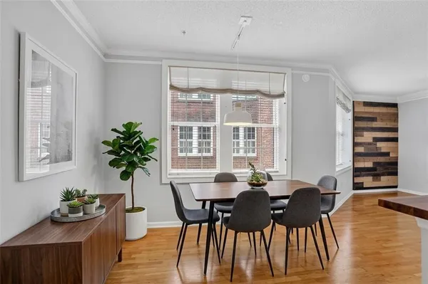 a view of a dining room with furniture window and wooden floor