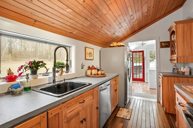 a kitchen with stainless steel appliances granite countertop a sink stove and cabinets