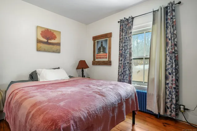 a bedroom with a large bed and a window