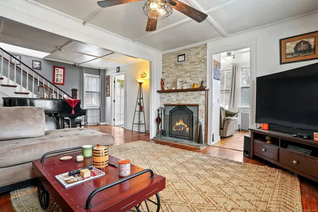 a living room with furniture a flat screen tv and a fireplace