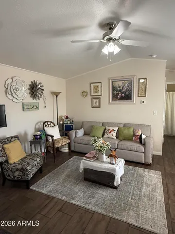 a living room with furniture and a chandelier