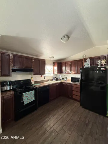 a large kitchen with stainless steel appliances and a refrigerator