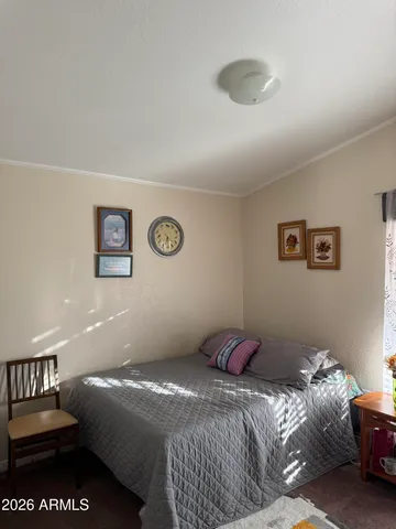 a bedroom with a bed and a lamp on table