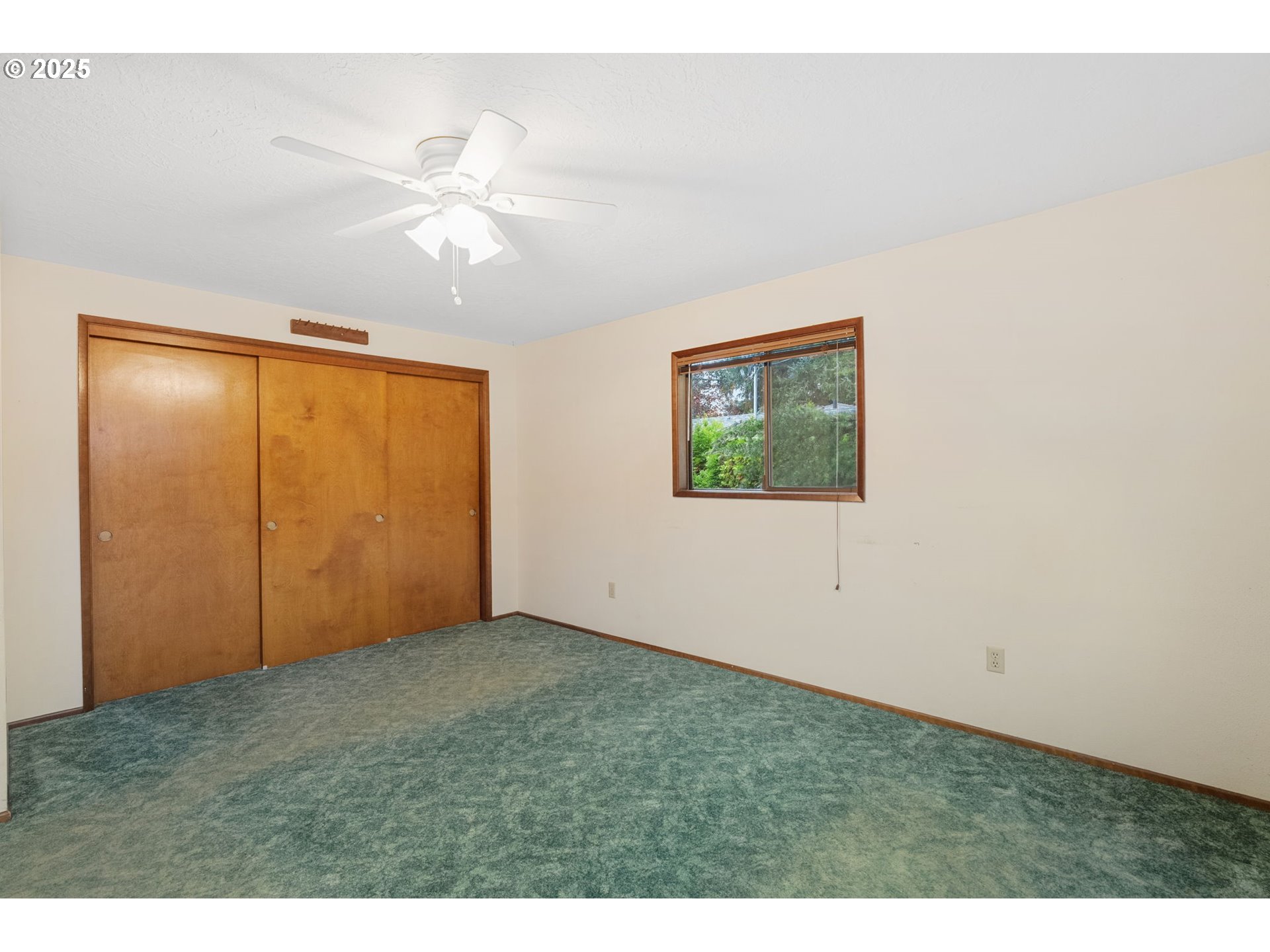 2433 Southeast Barnes Road Gresham, OR 97080 - Photo 16 of 27 a view of an empty room with window and chandelier fan
