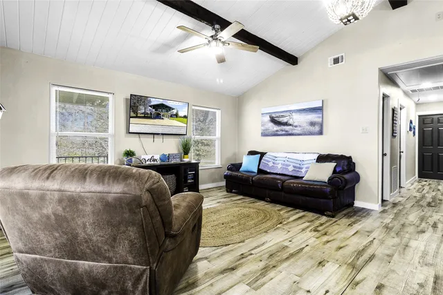 a living room with lots of furniture and kitchen view