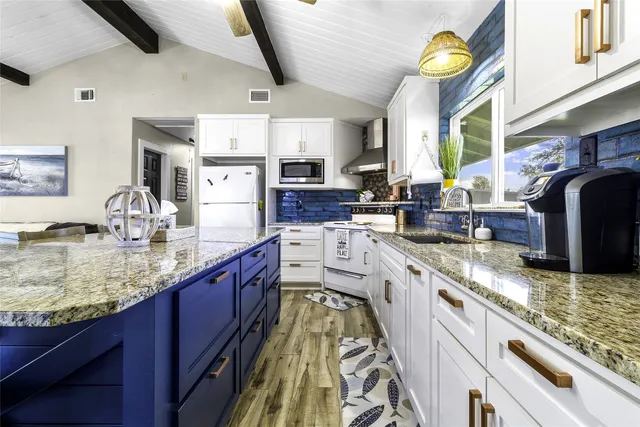 a living room with stainless steel appliances granite countertop furniture a couch a dining table and kitchen view