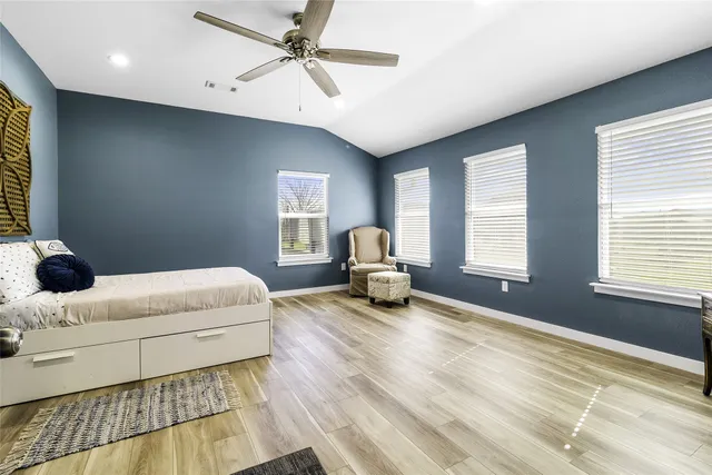 a bedroom with a bed and a couch