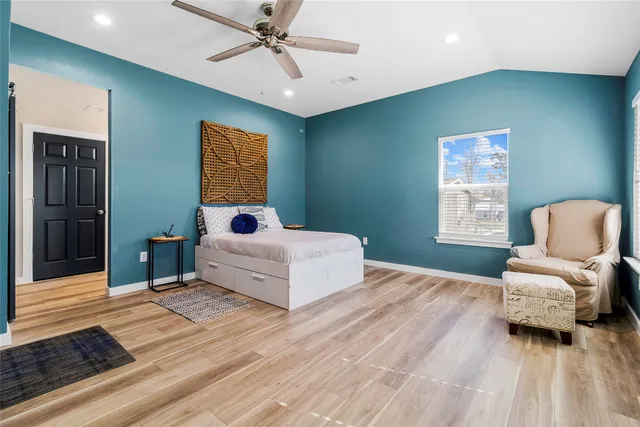 a bathroom with a sink and mirror with bathtub