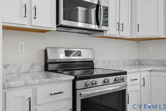 a sink with a granite countertop white sink and a window