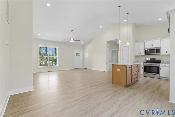 a view of a small space with wooden floor and a window