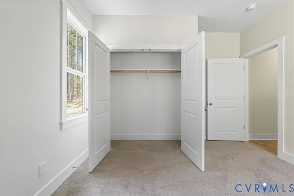 a view of a house with large windows and wooden fence