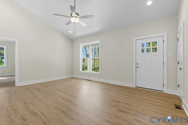 wooden floor in an empty room with a window